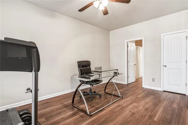 staircase with white cabinets and wooden floor