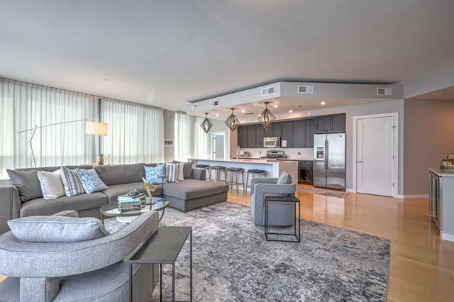 a living room with furniture and a large window