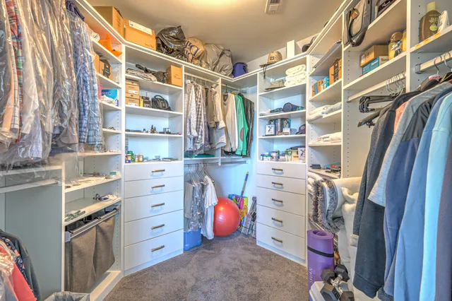 a spacious bathroom with a double vanity sink toilet mirror and shower