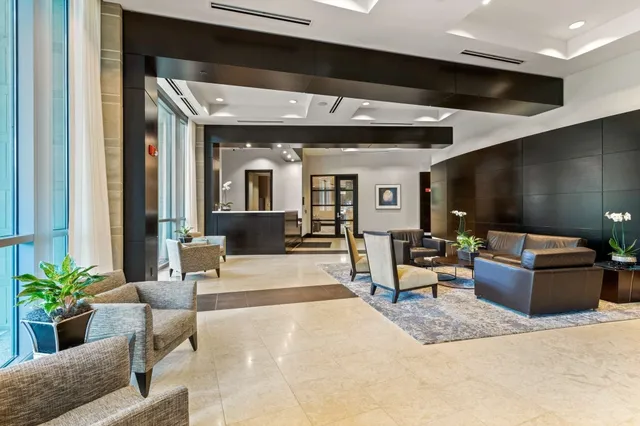 a view of a hallway with bathroom and a mirror
