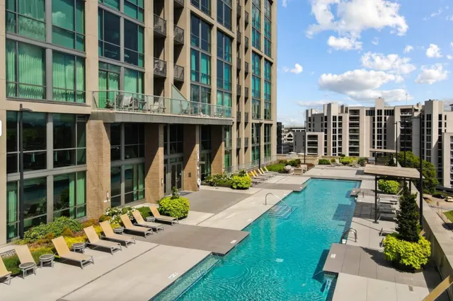 a view of a swimming pool and deck in the backyard