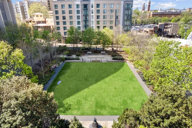 a kitchen with stainless steel appliances kitchen island granite countertop a table and chairs in it