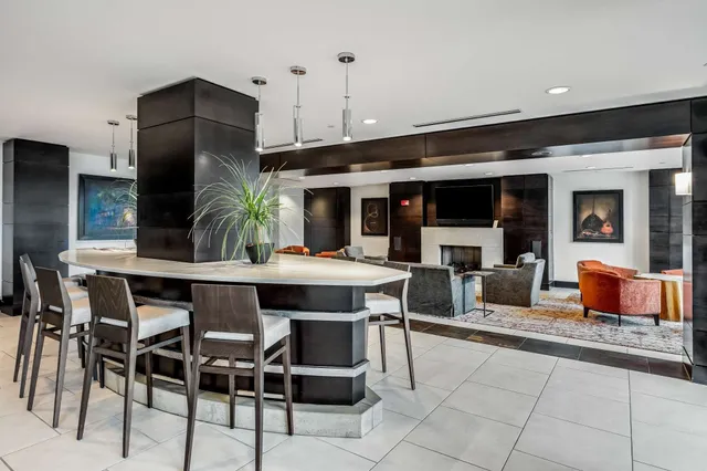 a living room with furniture a rug and a large window