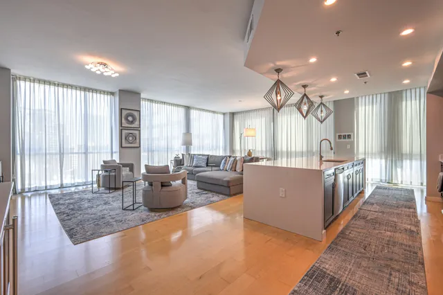 a dining room with furniture a window and a kitchen