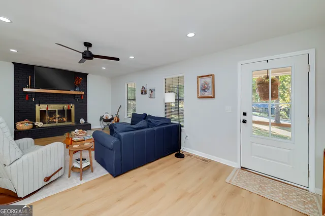 a living room with furniture a chandelier and a flat screen tv