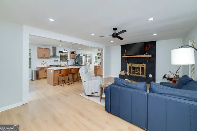 a living room with furniture and kitchen view