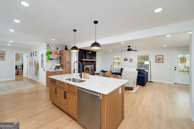a kitchen with a dining table chairs sink and cabinets