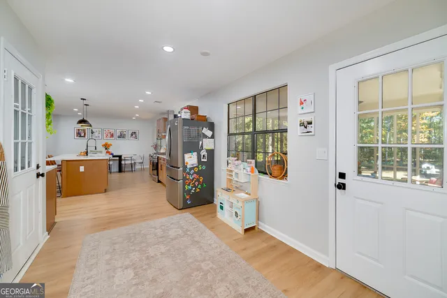 a living room with furniture a flat screen tv and a large window