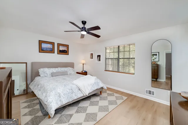 a bathroom with a double vanity sink a large mirror a shower and a bathtub