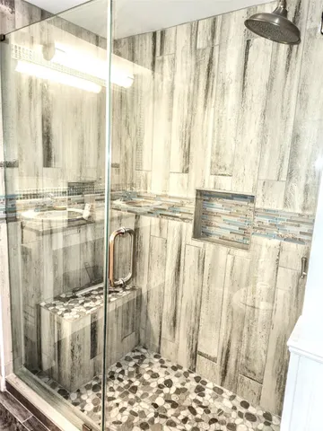 a bathroom with a shower and a tub