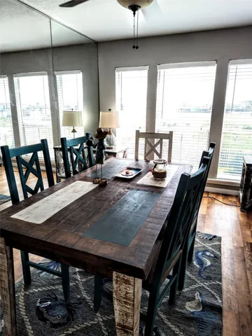 a dining room with furniture window and wooden floor
