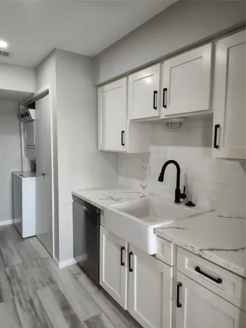 a kitchen with a sink cabinets and stainless steel appliances