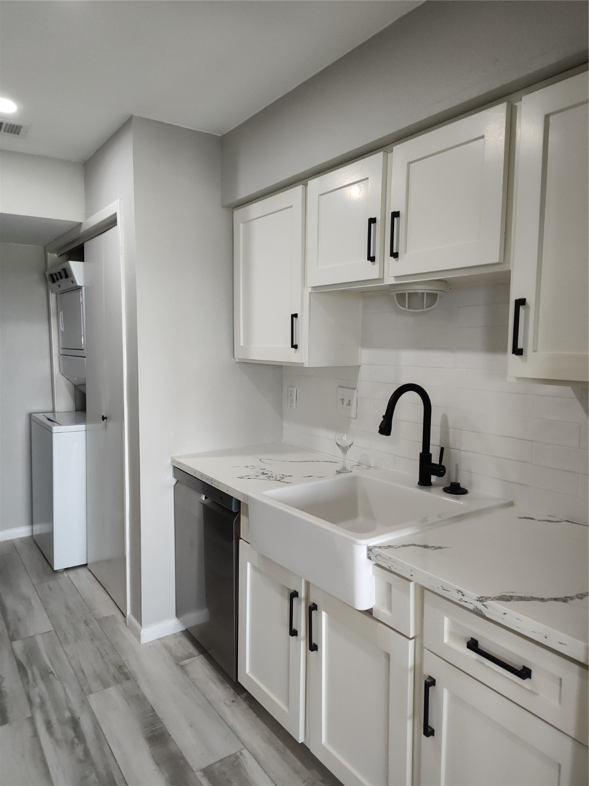 500 Tiki Drive, Unit 213 Tiki Island, TX 77554 - Photo 7 of 25 a kitchen with a sink cabinets and stainless steel appliances