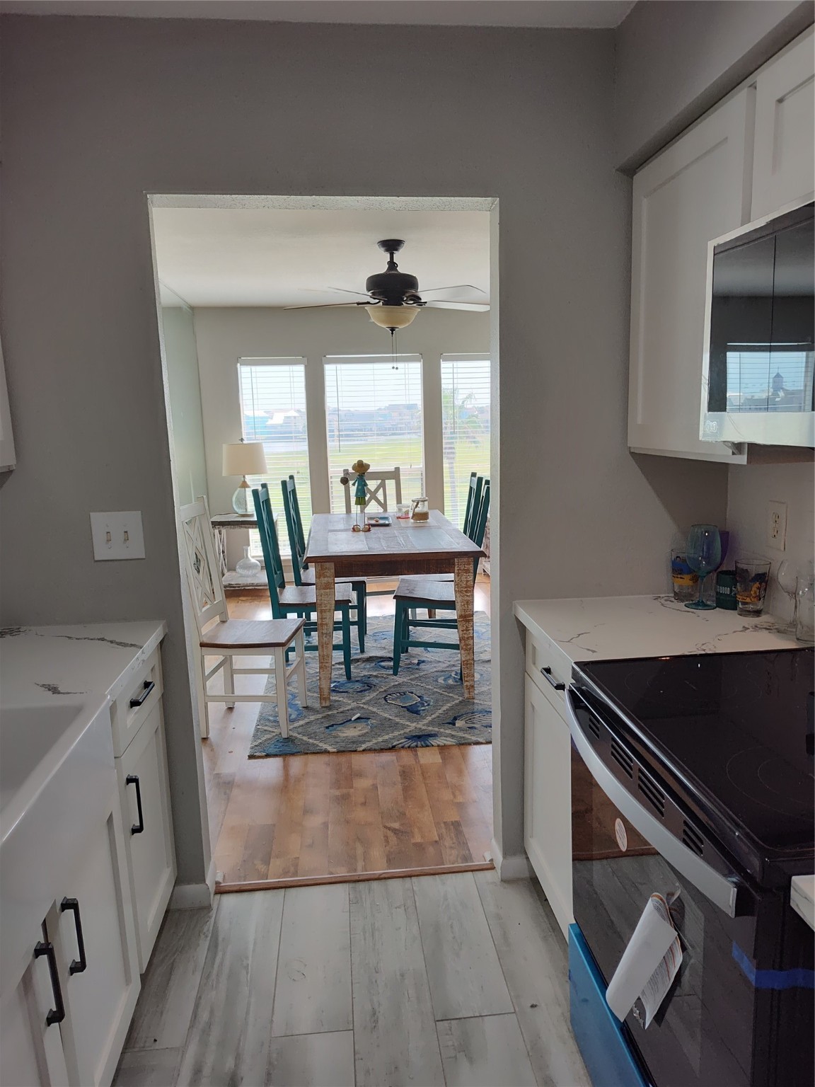 500 Tiki Drive, Unit 213 Tiki Island, TX 77554 - Photo 8 of 25 a view of a kitchen with kitchen island a counter top space a sink a stove and wooden floor