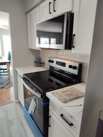 a kitchen with a stove and a microwave