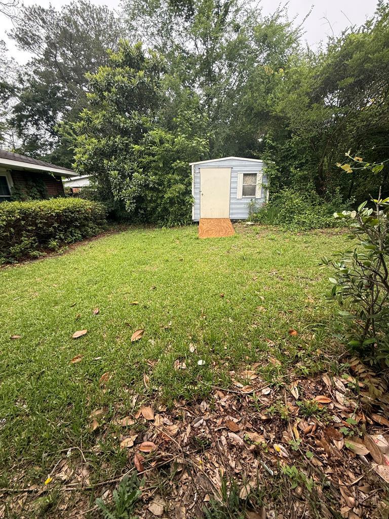 4355 Byron Street Columbus, GA 31907 - Photo 18 of 20 a backyard of a house with lots of plants and trees