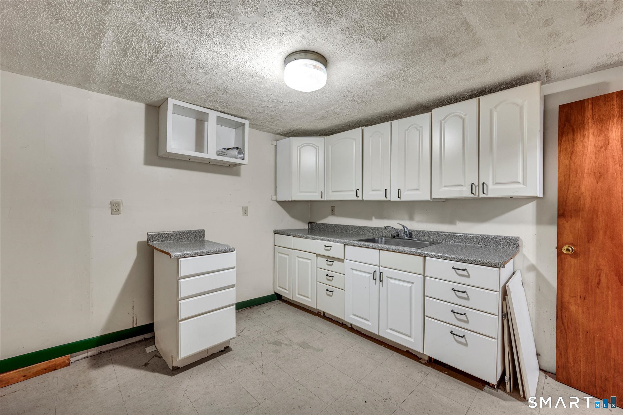 740 Rainbow Road Windsor, CT 06095 - Photo 33 of 40 a kitchen with cabinets and white appliances
