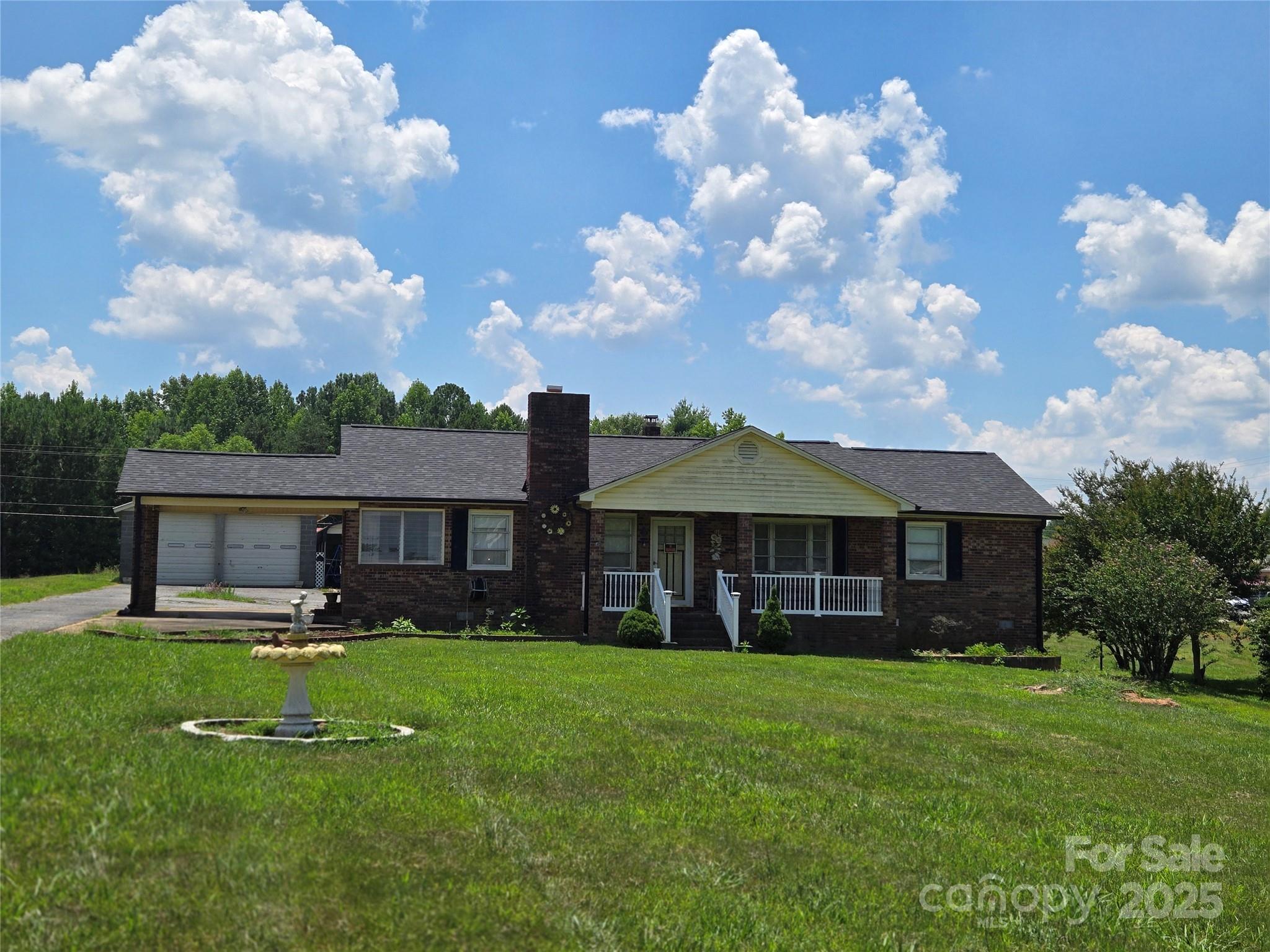 a view of a house with a yard porch and sitting area