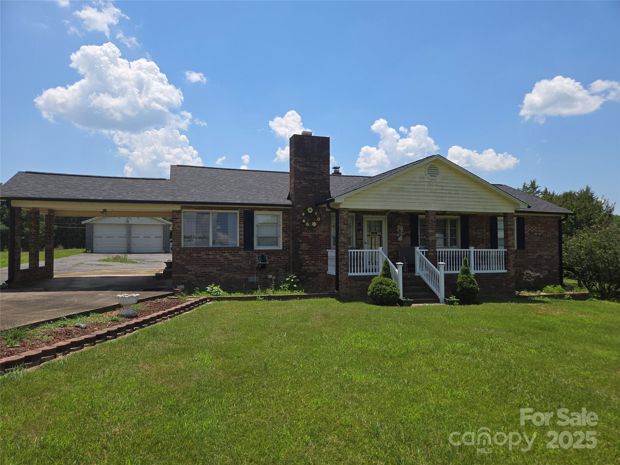 541 Old NC 277 Road Bessemer City, NC 28016 - Photo 15 of 26 a front view of a house with a yard table and chairs