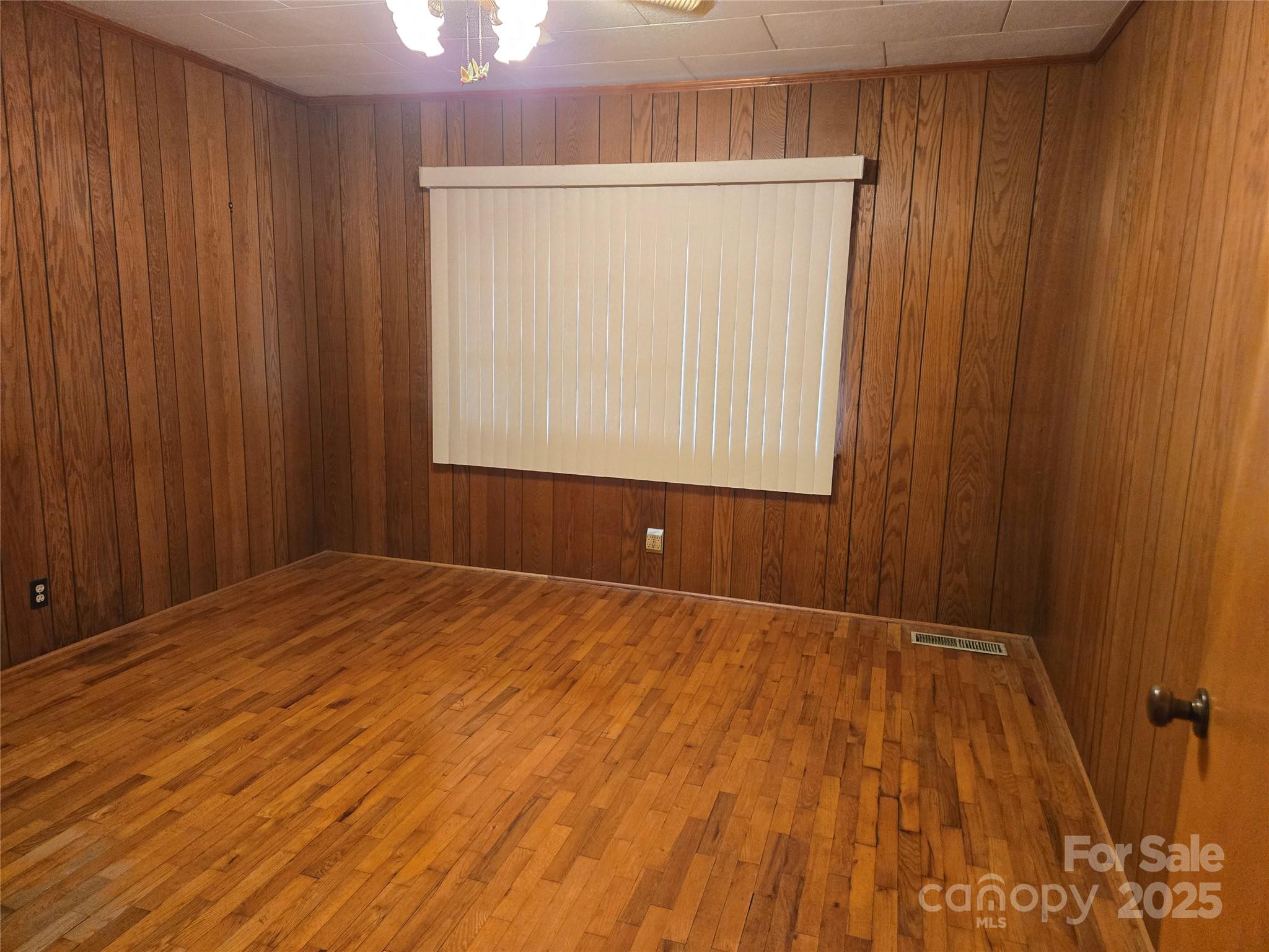 541 Old NC 277 Road Bessemer City, NC 28016 - Photo 21 of 26 a view of an empty room with wooden floor and a window