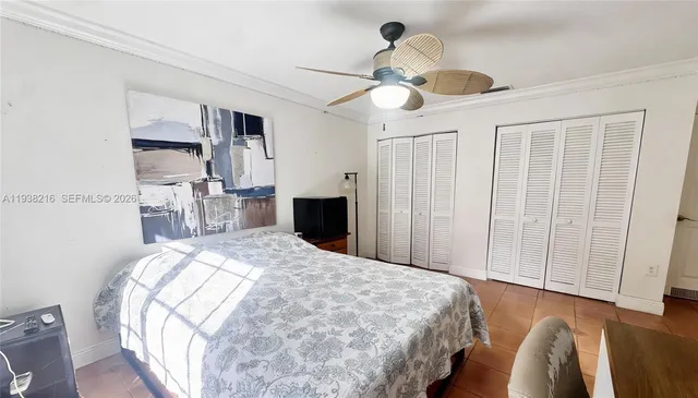 a bedroom with bed and a chandelier