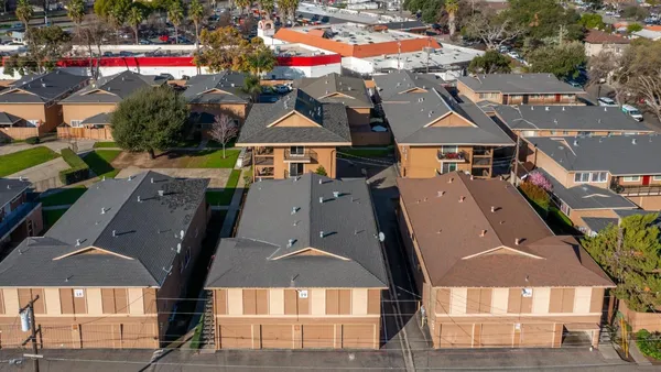 an aerial view of multiple houses with yard