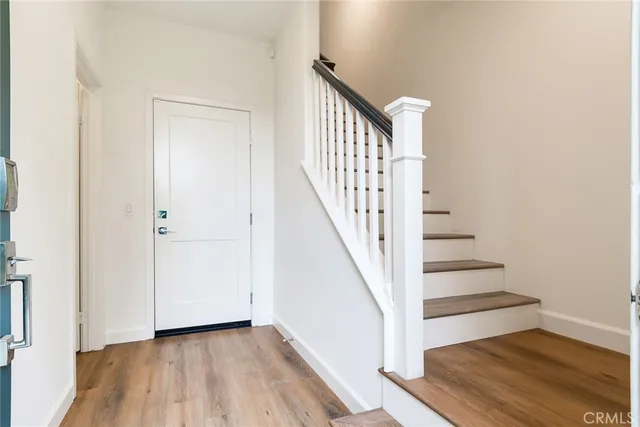 a view of a hallway with wooden floor and entryway