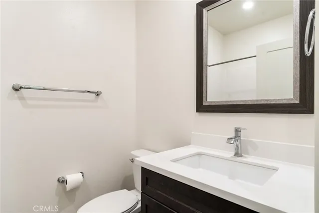a bathroom with a sink a toilet and mirror
