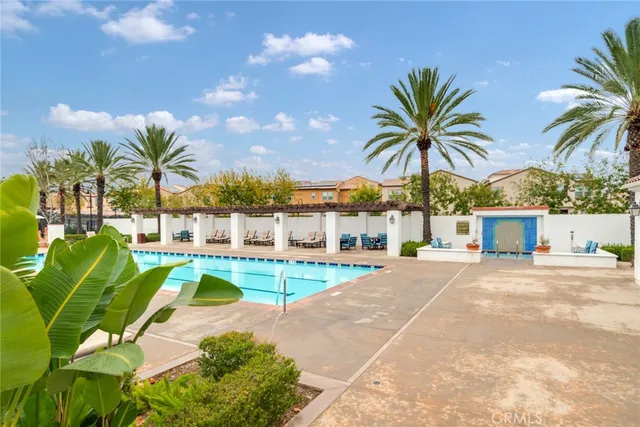 a view of a backyard with a patio and palm trees