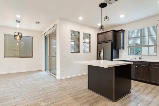 a large kitchen with kitchen island a sink stainless steel appliances and cabinets
