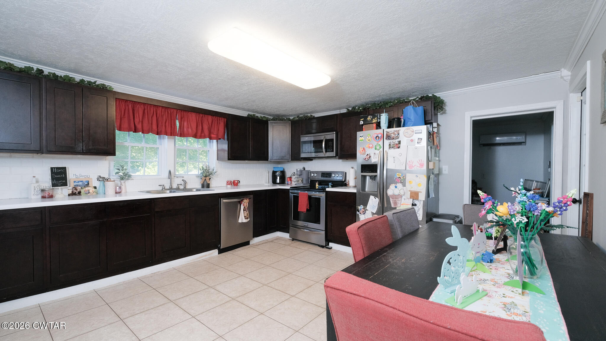 2636 Sidonia Road Sharon, TN 38255 - Photo 6 of 22 a kitchen with stainless steel appliances kitchen island granite countertop a refrigerator a sink dishwasher a dining table and chairs with wooden floor