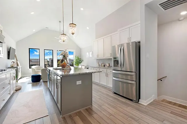 a kitchen with kitchen island a counter top space a sink appliances and cabinets