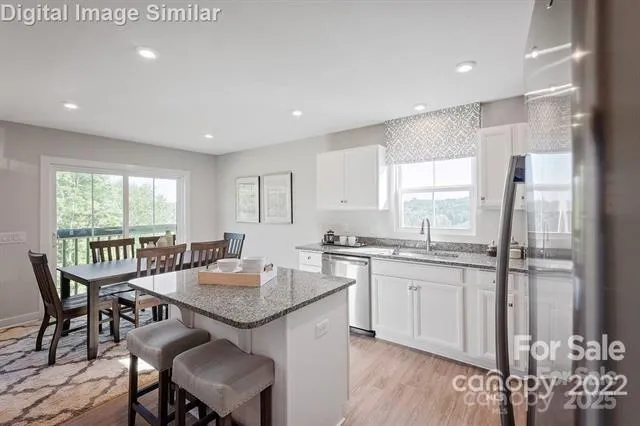 a kitchen with granite countertop sink dining table and chairs
