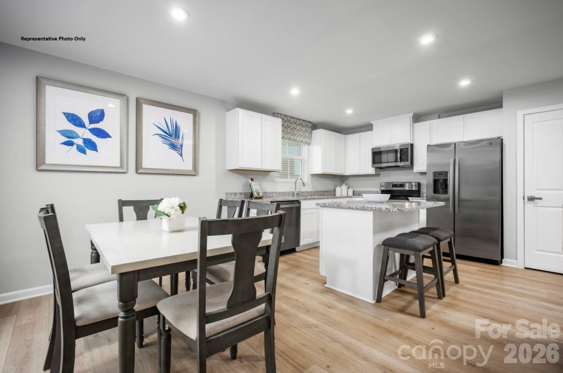 304 Maggys Way Pageland, SC 29728 - Photo 4 of 13 a view of kitchen with refrigerator dining table and chairs