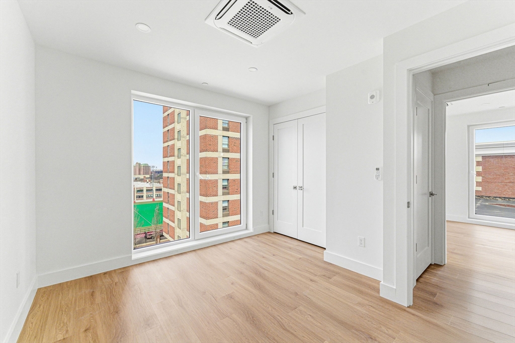 1035 Commonwealth Avenue, Unit 610 Boston, MA 02215 - Photo 12 of 18 wooden floor in an empty room with a window