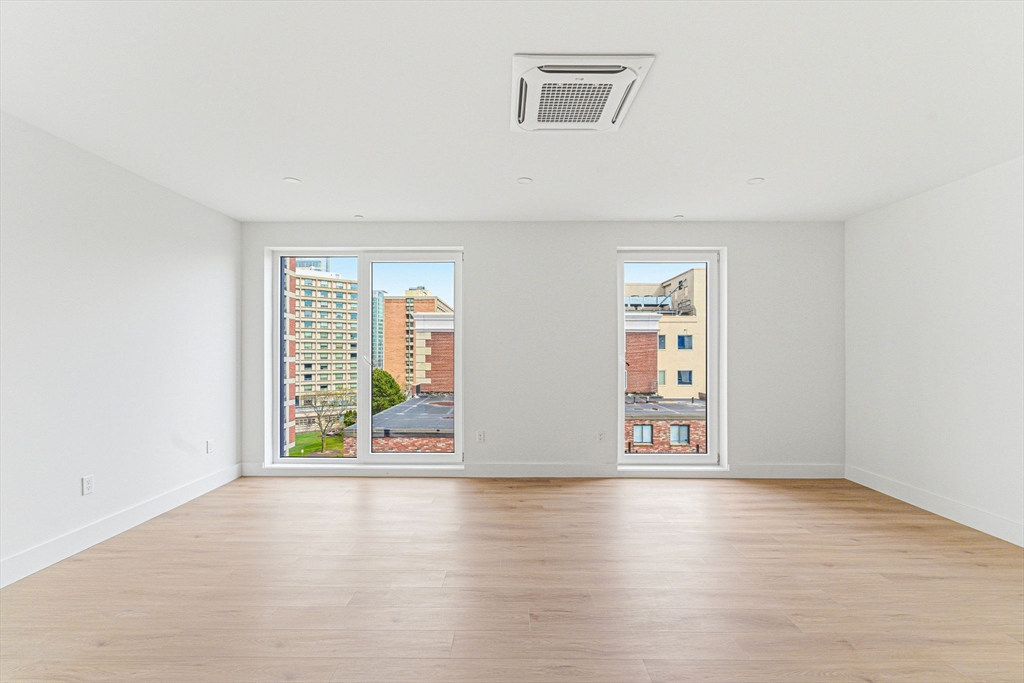 1035 Commonwealth Avenue, Unit 610 Boston, MA 02215 - Photo 4 of 18 an empty room with windows