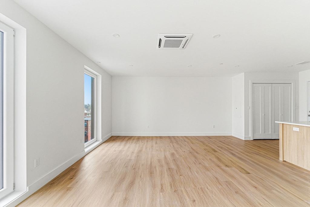 1035 Commonwealth Avenue, Unit 610 Boston, MA 02215 - Photo 6 of 18 a view of a room with wooden floor and white walls