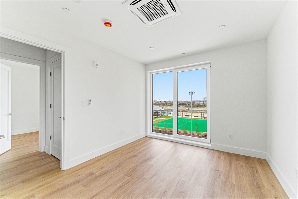 1035 Commonwealth Avenue, Unit 610 Boston, MA 02215 - Photo 10 of 18 a view of an empty room with wooden floor and a window