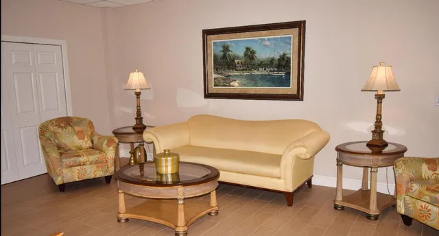 a bedroom with furniture and a lamp