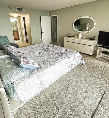 a bedroom with a bed and a mirror