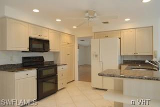330 Springline Drive Naples, FL 34102 - Photo 3 of 8 a kitchen with kitchen island granite countertop a stove a sink and a refrigerator