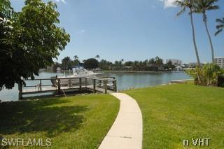 330 Springline Drive Naples, FL 34102 - Photo 8 of 8 a view of a swimming pool with a lake view
