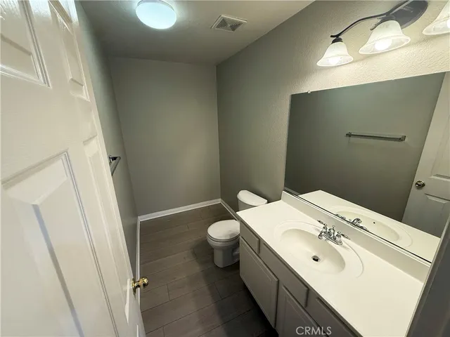 a bathroom with a sink and mirror with toilet