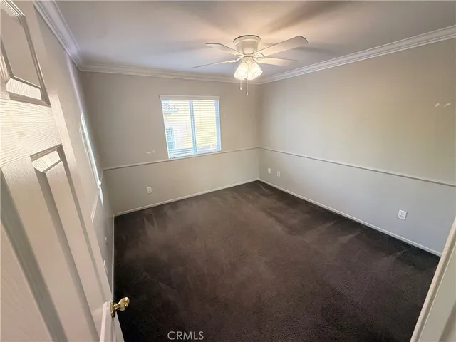 en empty room with windows and fan