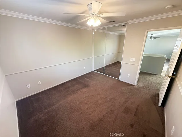 a view of a livingroom with a ceiling fan and window