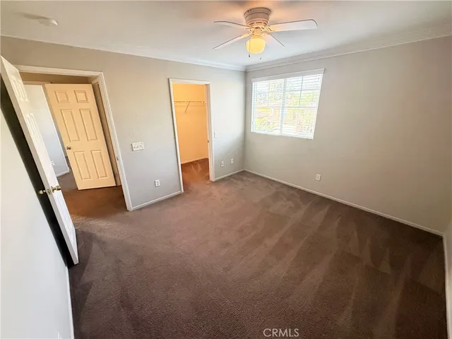 an empty room with windows and wooden door