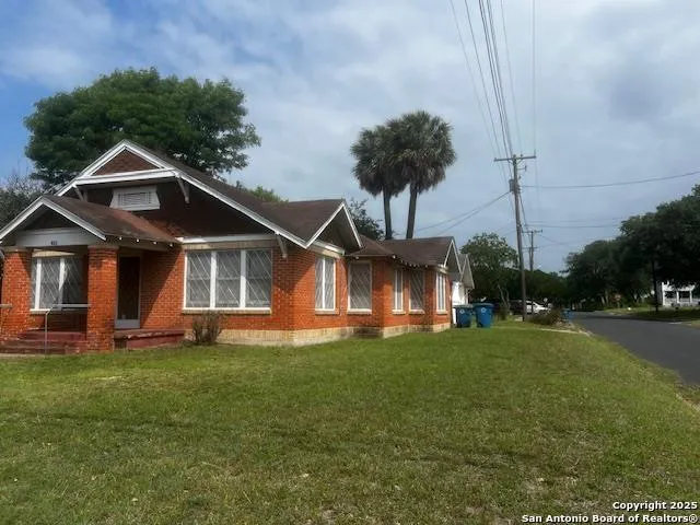 a view of house with backyard space and garden