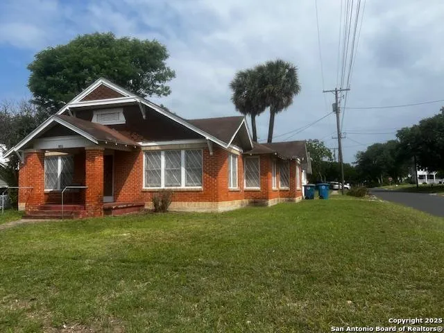 a front view of a house with a garden and deck