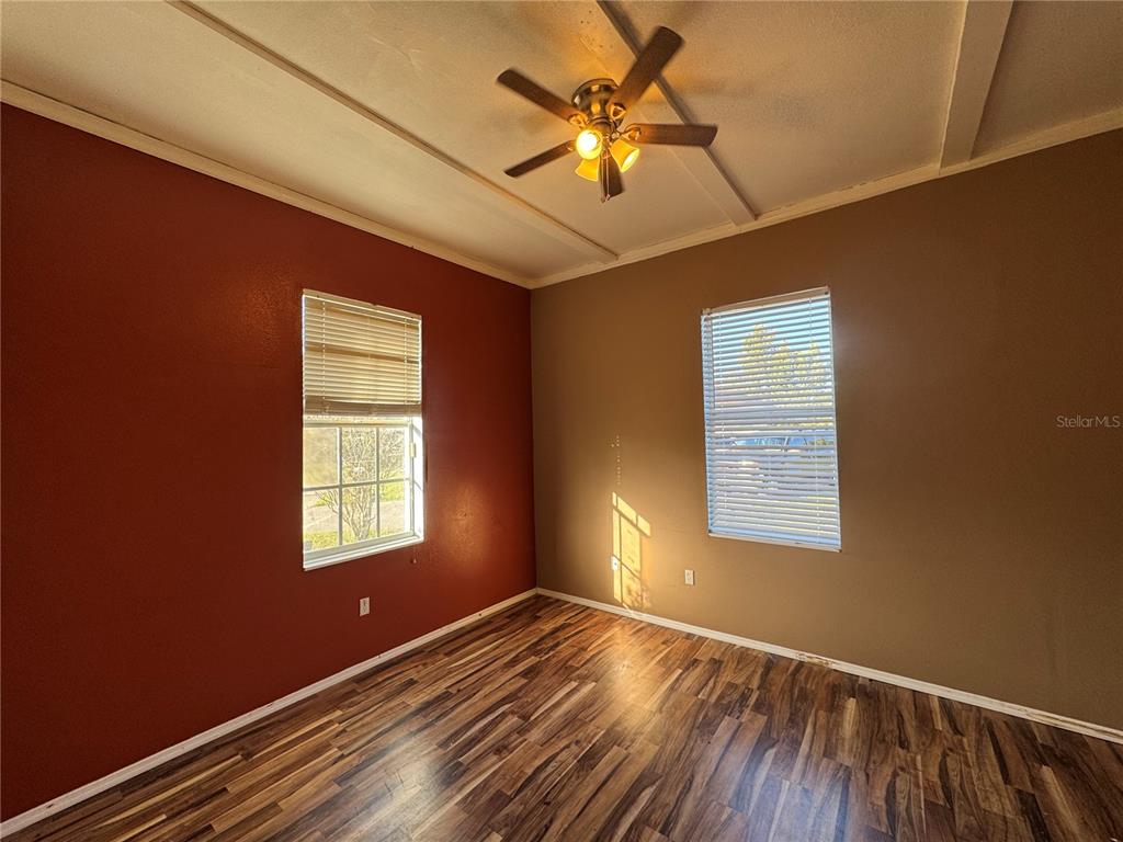 12349 Wasatch Court New Port Richey, FL 34654 - Photo 12 of 34 a view of an empty room with a window and wooden floor