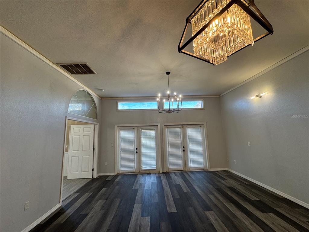 12349 Wasatch Court New Port Richey, FL 34654 - Photo 14 of 34 an empty room with wooden floor chandelier and entryway